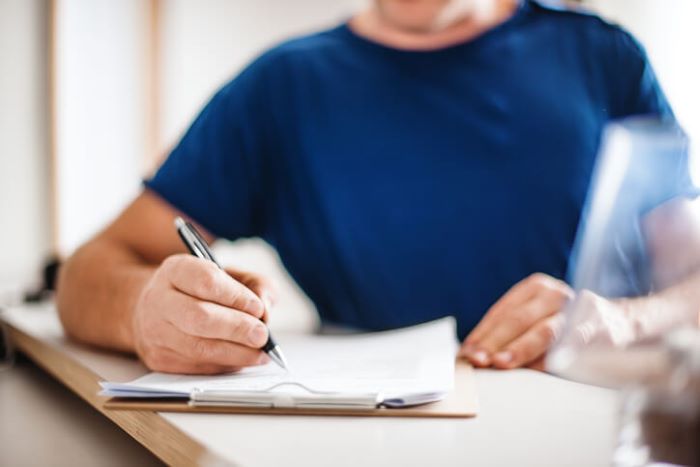 Photo of a man filling out papers