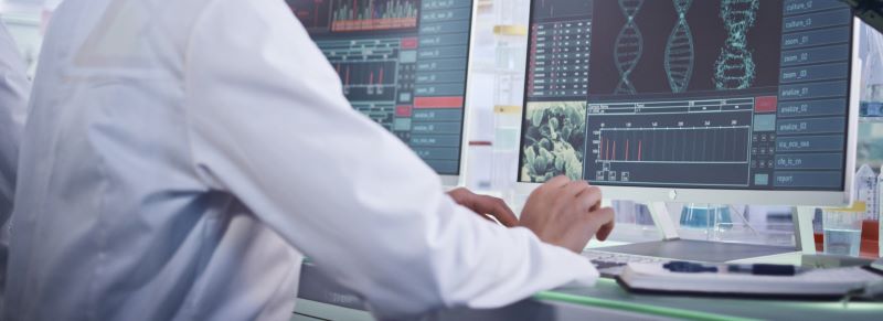 A scientist checking DNA on a computer.